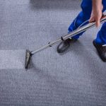 man vacuuming carpet