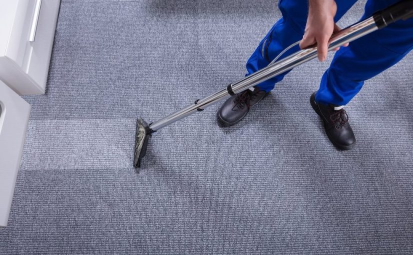 man vacuuming carpet